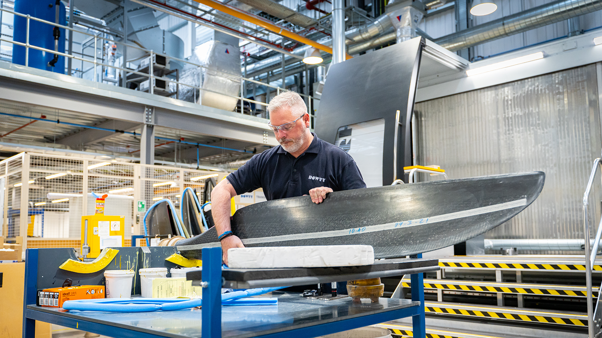 Dowty employee holding propeller blade